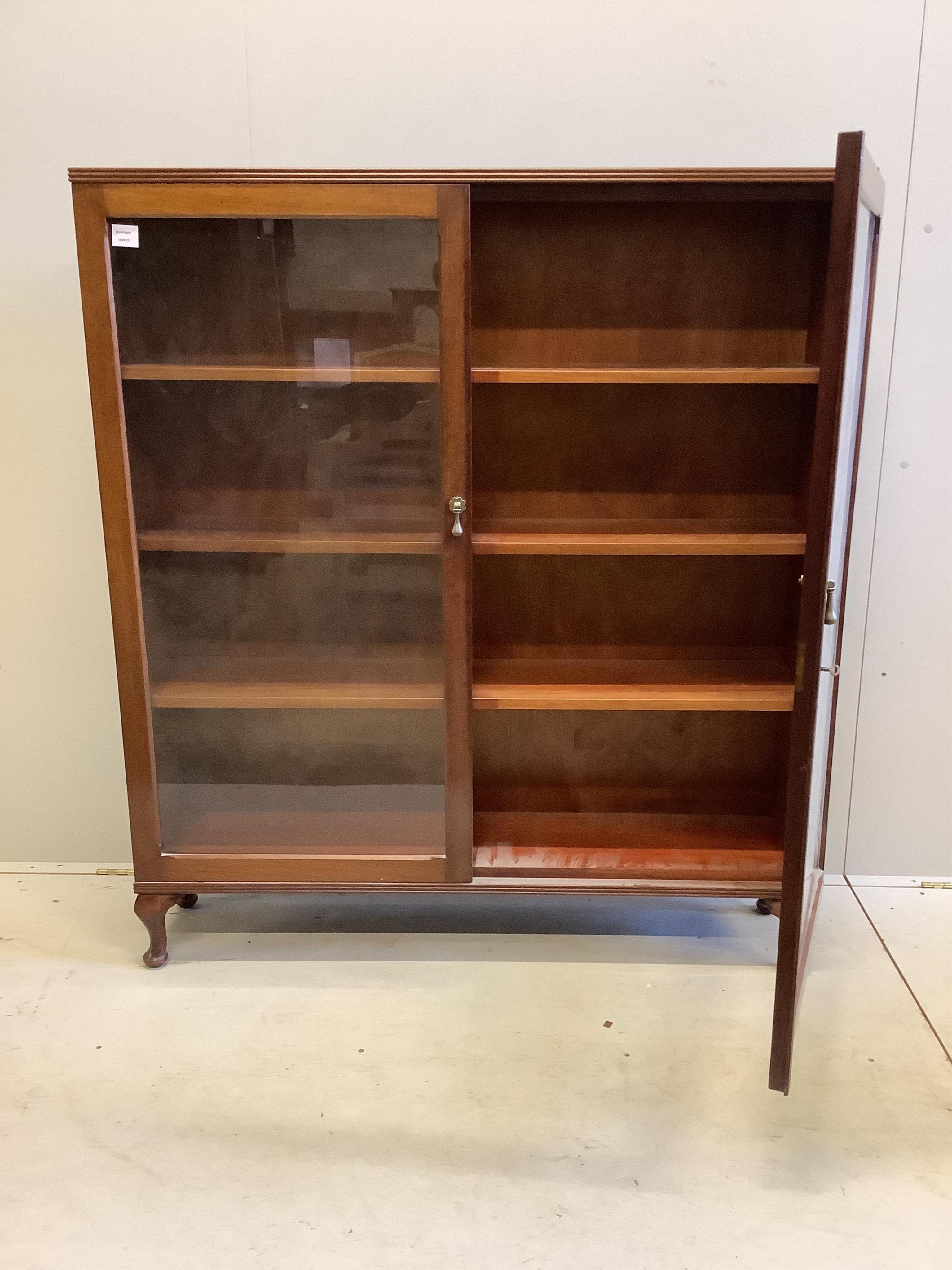 An early 20th century mahogany glazed two door bookcase, width 123cm, depth 27cm, height 139cm. Condition - good